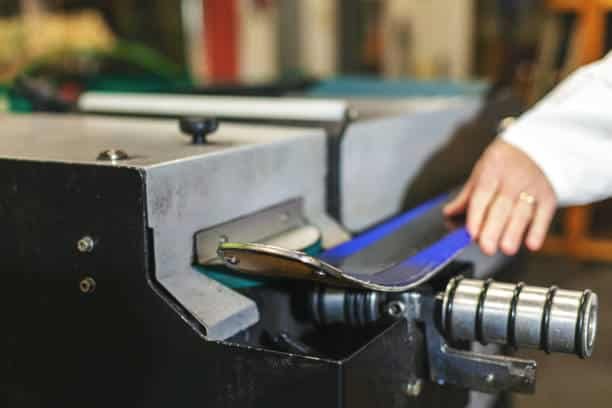 Crowns Machinery rubber extruder in operation, producing blue rubber profile
